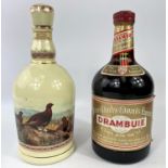 A Wade ceramic bottle containing 70 cl of Famous Grouse Scotch whisky; a 1 litre bottle of Drambuie