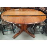 An Ercol elm oval extending dining table