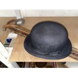 A 1930's aneroid barometer, 2 walking sticks and a bowler hat