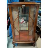 A 1930's walnut single door display cabinet