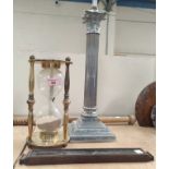 A chromed Corinthian column table lamp; a brass framed hourglass; a thermometer