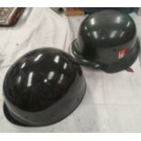 A German style steel helmet, leather lining and a plastic helmet.