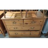 An Edwardian stripped pine chest of 2 long and 2 short drawers