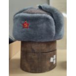 A Russian Soviet era, lined wool hat with enamel badge and an old pine hat mould.