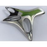 A George Jensen silver abstract brooch designed by Henning Koppel, pierced and with green enamel