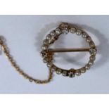 A late 19th century gold circular brooch set 4 diamonds and 20 seed pearls, brooch tests 18 carat