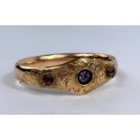 A Victorian gold plated bangle with 3 amethyst coloured stones in acanthus setting