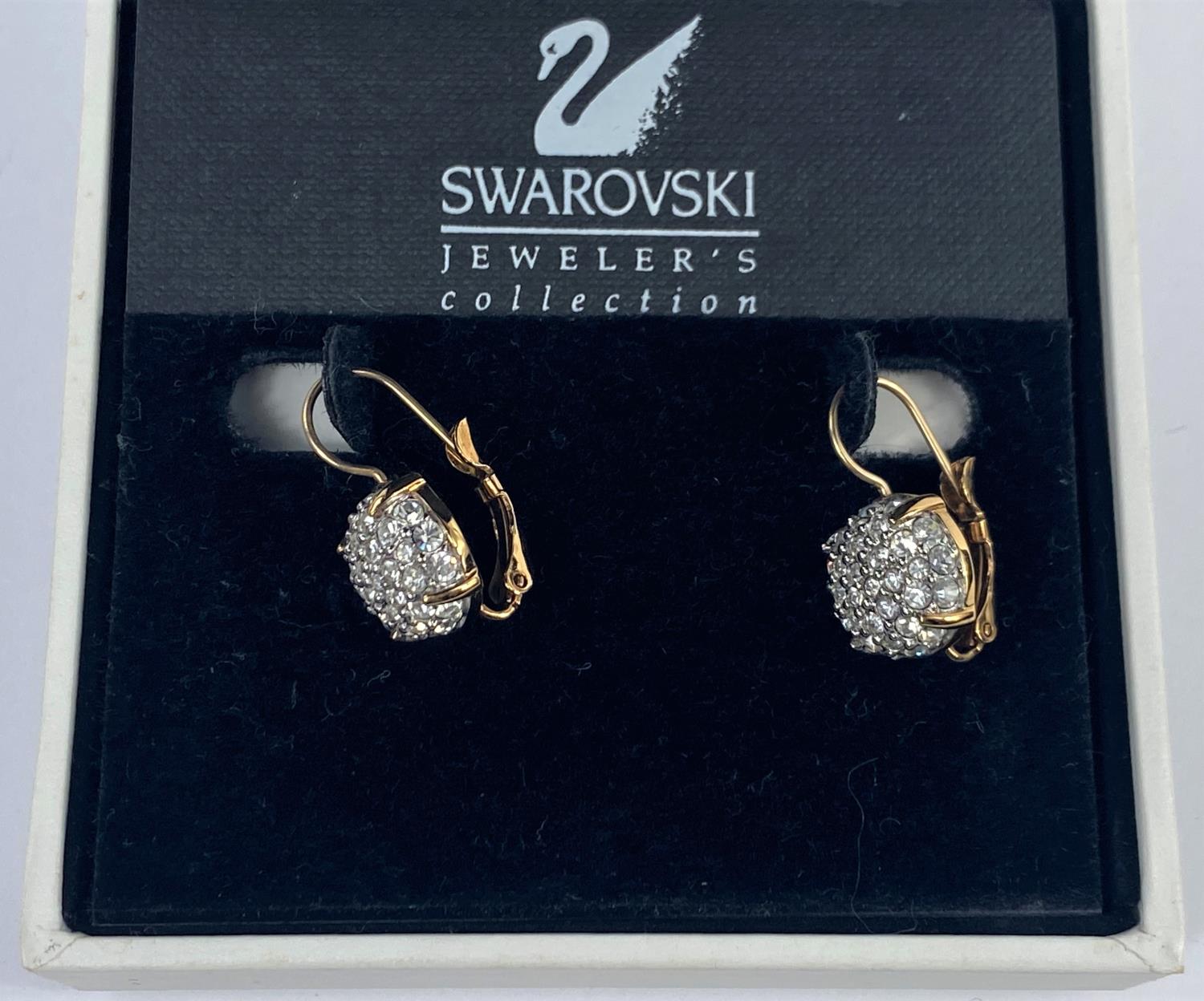 A pair of Swarovski cluster gem set earrings, cased