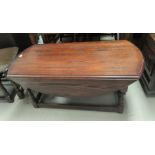 An "Old Charm" reproduction 2 tier coffee table with oval drop leaf top