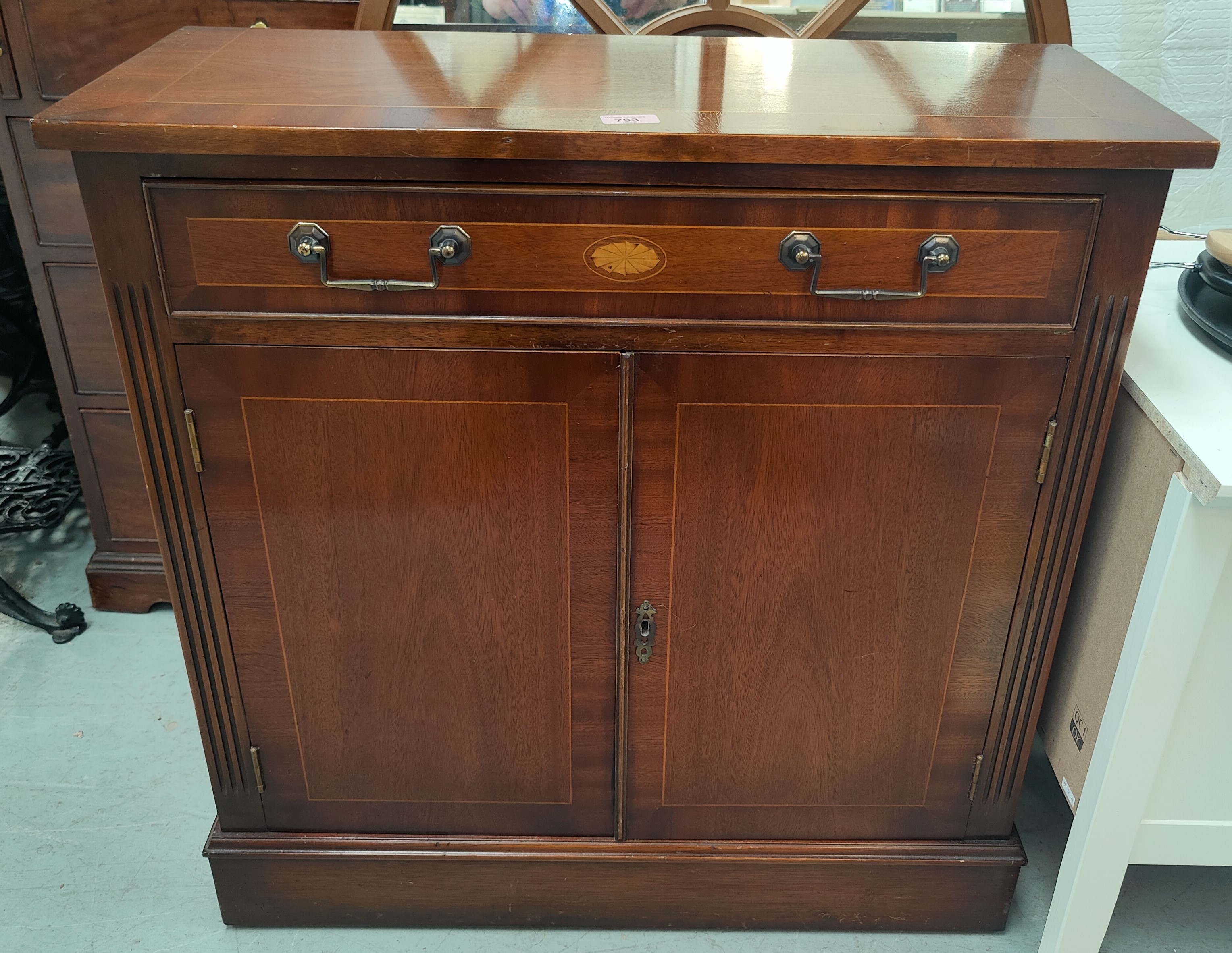 A reproduction inlaid mahogany side cabinet with frieze drawer and double cupboard