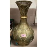 A 19th century middle eastern brass vase with relief decoration and script 43cm