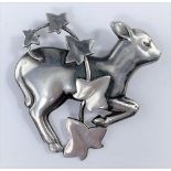 A Georg Jensen silver brooch designed by Arno Malinowski: a gambolling lamb with strand of ivy, No