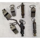 Three vintage Police whistles and four railway whistles