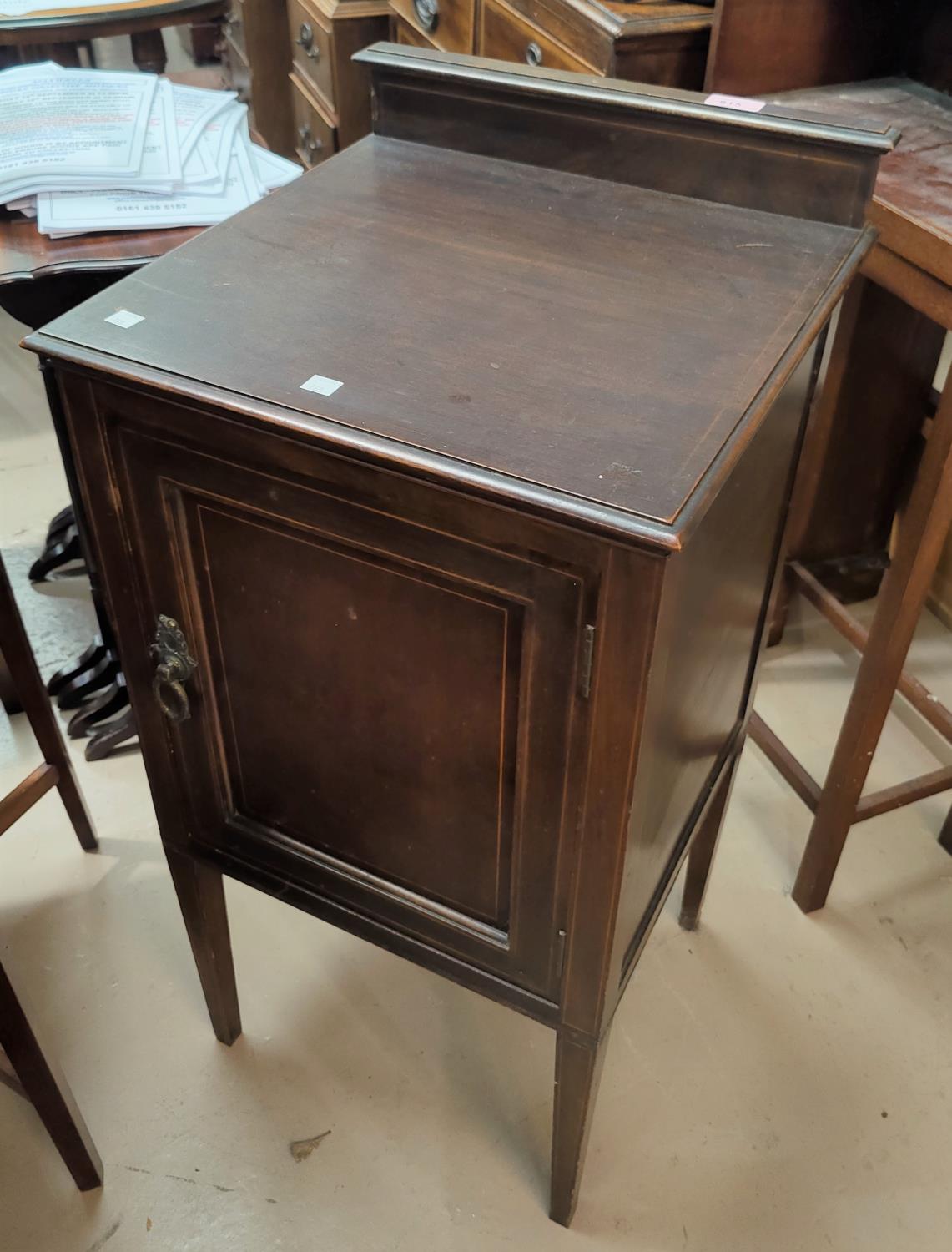 An Edwardian mahogany ledgeback bedside cupboard, inlaid stringing decoration