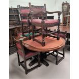 A Jacobean style oak dining suite comprising oval drop leaf table and 6 (4+2) chairs with carved top