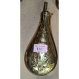 A large American brass powder flask with embossed trophy and eagle, 23cm