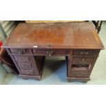 An Edwardian stained mahogany kneehole desk with inset top, 3 frieze and 6 pedestal drawers