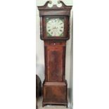 An early 19th century longcase clock in crossbanded figured mahogany with swan neck pediment and