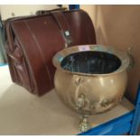 A brass cauldron on 3 paw feet, diameter 22cm; a walnut nutmeg grinder & a brown briefcase.