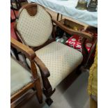 A Victorian mahogany armchair on cabriole legs with ball and claw feet in cream fabric;