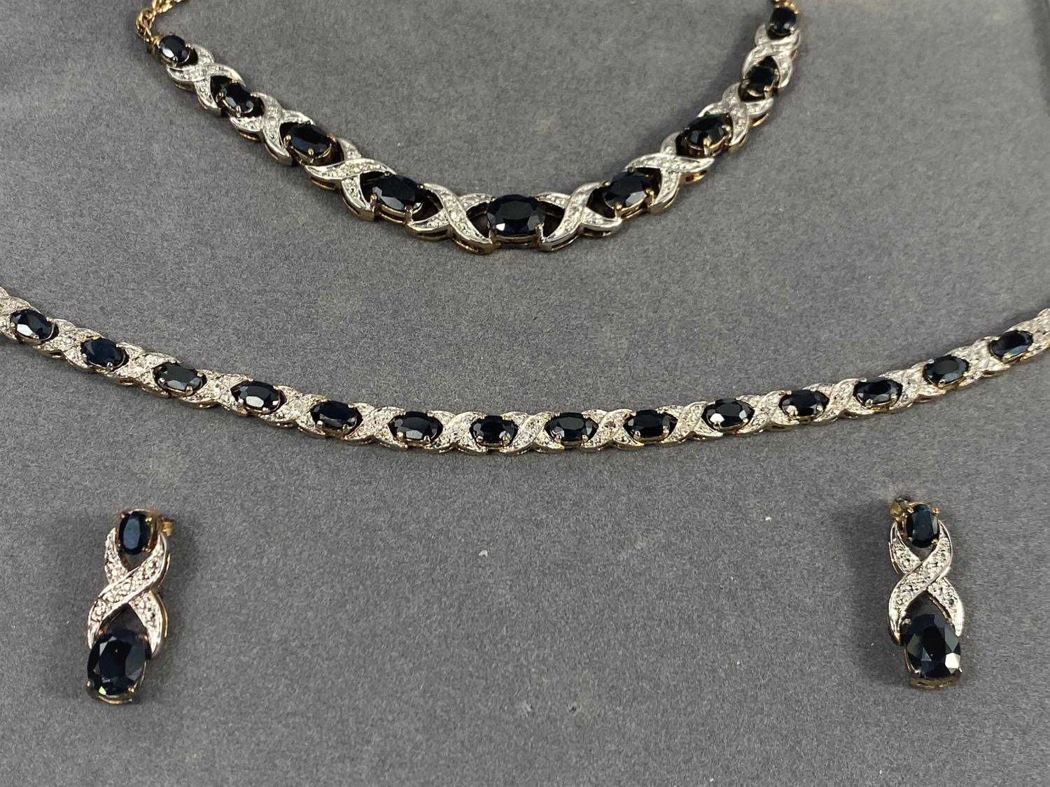 A silver gilt suite comprising necklace, bracelet and earrings, set dark blue and clear stones, - Image 3 of 4