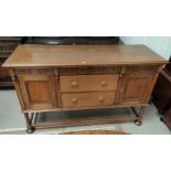 A 1930's golden oak sideboard of 2 cupboards and 2 drawers, on barley twist legs