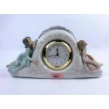 A Lladro porcelain clock, numbered 5776, with quartz movement & two young girls sat either side,