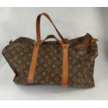 A Louis Vuitton 'sacsouple'/keepall, monogrammed, with tan leather strapping and handles, zip tab