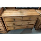 A stripped pine chest of 2 long and 2 short drawers