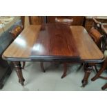 A Victorian mahogany wind out dining table with rounded rectangular top, with 1 leaf and winding