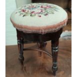 A Victorian mahogany revolving piano stool; an Edwardian walnut Sutherland table
