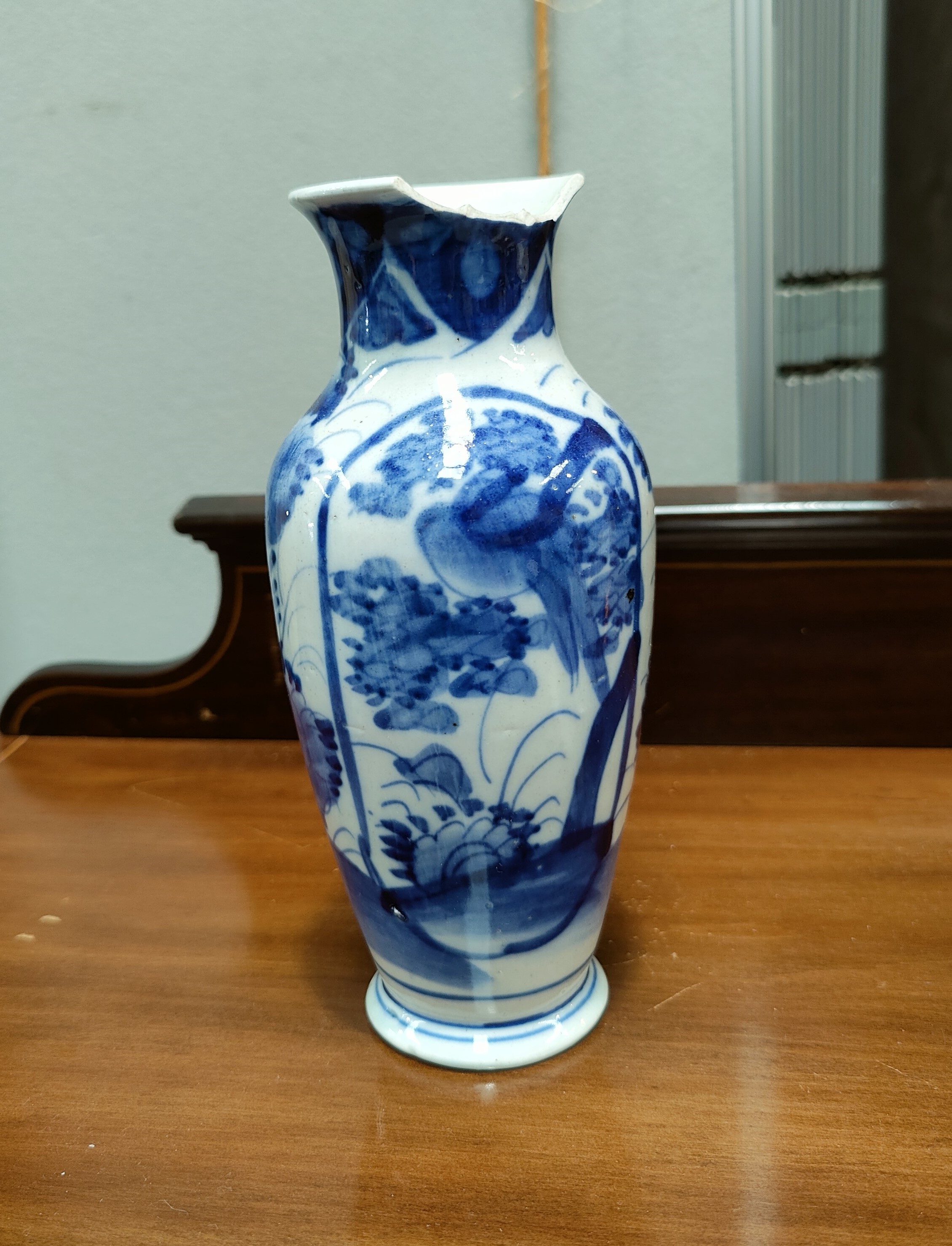 A Chinese blue and white baluster vase, floral and bird decoration, large chip to rim; a continental