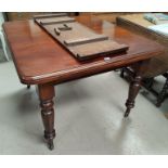 A Victorian mahogany wind-out dining table on turned legs and castors, 1 spare leaf and winder,