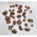 A collection of 7 Royal Marine cap badges, 6 shoulder tags and a quantity of buttons etc