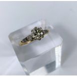 A yellow metal ring set diamond solitaire stone of 1.10 metric carat approx, each shoulder set 3