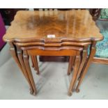 A nest of 3 walnut occasional tables; a nest of 3 mahogany occasional tables