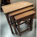 A reproduction oak coffee table; a reproduction oak nest of 3 tables
