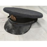 A mid 20th century Royal air Force cap with a brass badge, dated 1952