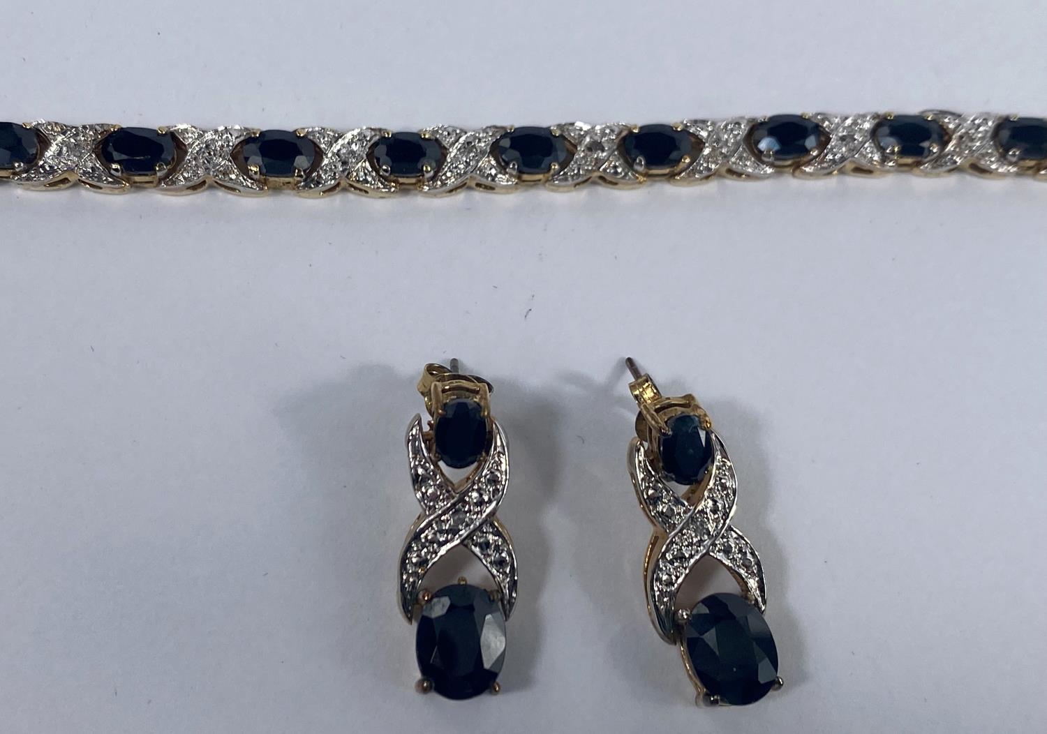 A silver gilt suite comprising necklace, bracelet and earrings, set dark blue and clear stones, - Image 4 of 4