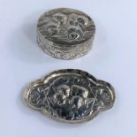 A hall marked silver pill box embossed with cherubs and a matched hall marked silver pin dish