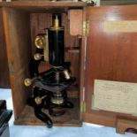A COMPOUND MICROSCOPE by W.WATSON and SONS, lacquered brass, with vernier micrometer stage, mahogany