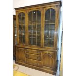 An oak "Reprodux" library bookcase with three astragal glazed doors above, three central drawers