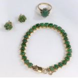 A suite of jewellery, set with cabochon cut green stones, comprising of: bracelet with clasp stamped