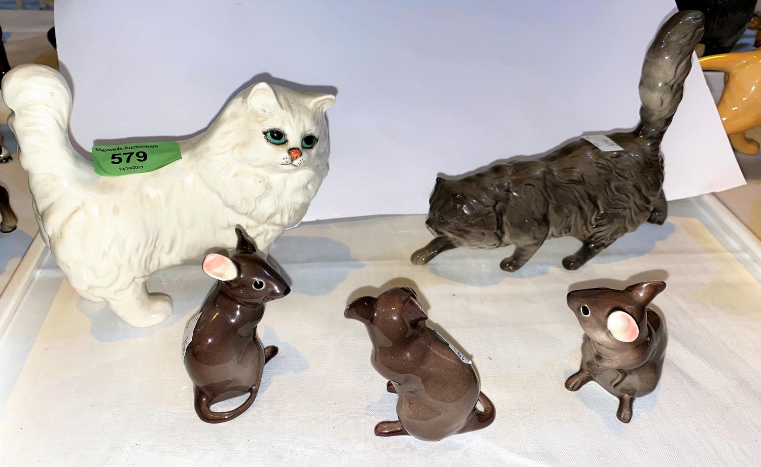 A Royal Doulton cat, a Beswick cat and three Beswick mice