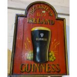 A vintage painted wooden 'Taste of Ireland' Guinness sign 92x63cm