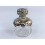 A hall marked silver mounted large squared globular glass scent bottle, with embossed cherub