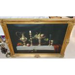 A large oil on canvas of a table laid with brass jug, candlestick etc with fruit in a bowl on a