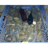 A collection of various vintage clear glass bottles