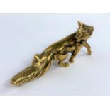 A heavy brass paperweight in the form of a fox, height 21cm.