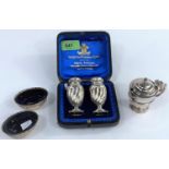 A pair of spiral ribbed pepper pots, cased, Birmingham 1893; a pair of spiral ribbed oval salts,